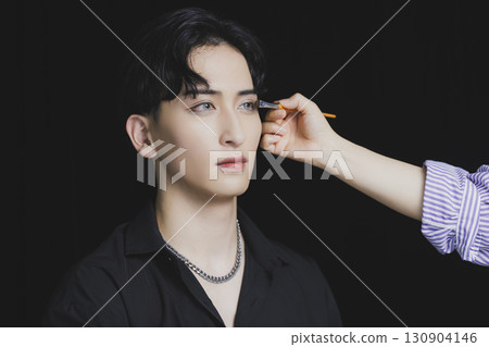 Young man putting on makeup 130904146