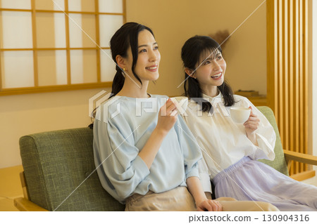 Two women drinking tea 130904316