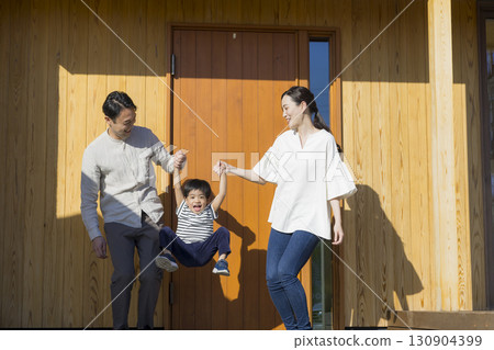 A family standing in front of a family 130904399
