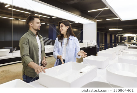 Couple choosing sink for bathroom in their house standing at building market planning repair. 130904401