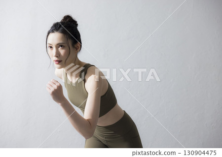 一個穿著訓練服伸展的女人 130904475