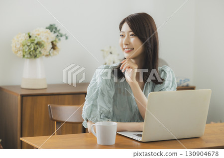 觀看一台計算機的婦女在屋子裡 130904678
