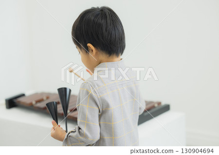 Child playing xylophone 130904694