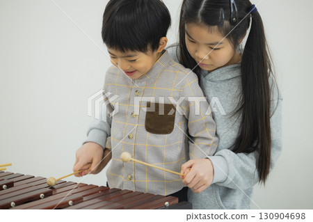 Child playing xylophone 130904698