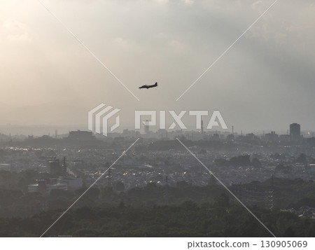 (Bird's-eye view) A small passenger plane landing at Chofu Airport from above the city at dusk 130905069