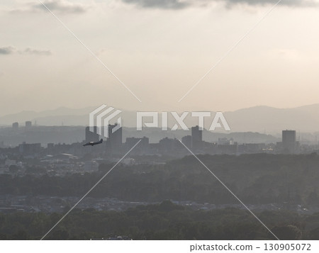 (Bird's-eye view) A small passenger plane landing at Chofu Airport from above the city at dusk 130905072