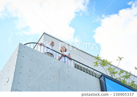 A middle-aged couple standing on the balcony. A middle-aged couple standing on the balcony. 130905337
