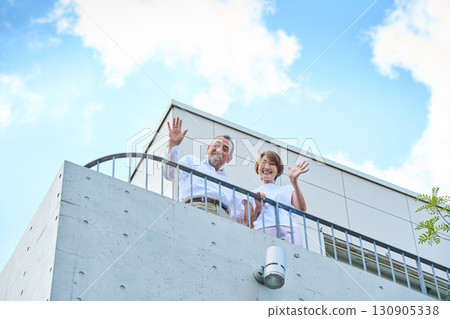 A middle-aged couple standing on the balcony. A middle-aged couple standing on the balcony. 130905338