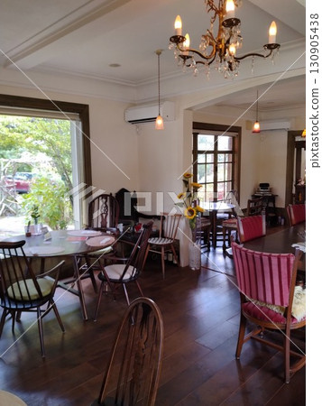 A stylish cafe with a view of the green scenery from the window 130905438