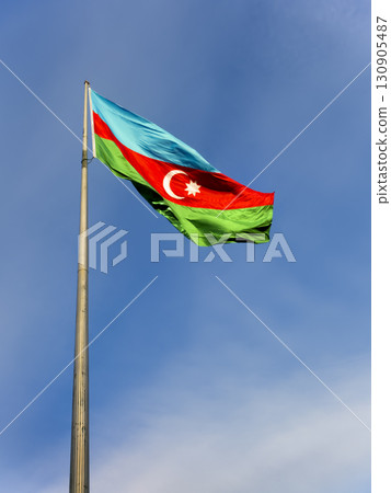 Flag of Azerbaijan fluttering against the blue sky Flag of Azerbaijan fluttering against the blue sky 130905487