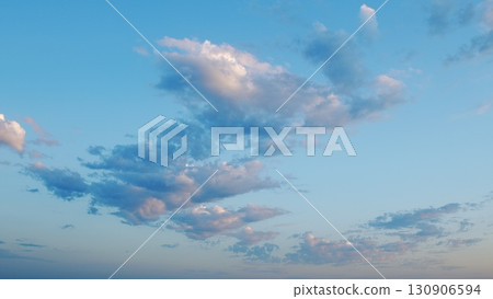 Stunningly Beautiful and Artistic Cloud Patterns Stretching Across a Clear Blue Sky Above Us 130906594