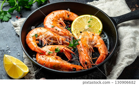 Sizzling fried shrimp with fresh vegetables in a pan, a delicious seafood dinner dish 130906682