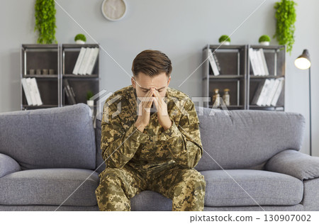 Sad Soldier Sitting On Sofa At Home 130907002