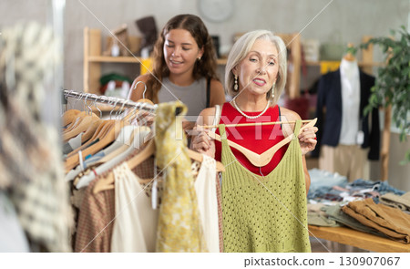 Elderly and young women choosing summer clothes in store Elderly and young women choosing summer clothes in store 130907067