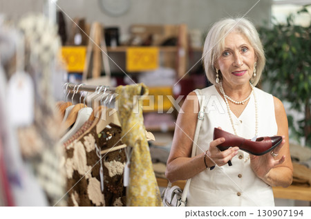 Mature woman choosing heels in clothing store 130907194