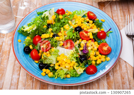 Mixed salad with corn, olives, cherry tomatoes and green lettuce Mixed salad with corn, olives, cherry tomatoes and green lettuce 130907265