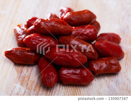 Spanish sausage chistorritas on the table, closeup 130907387