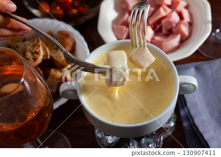 Cheese fondue with bread and snacks 130907411