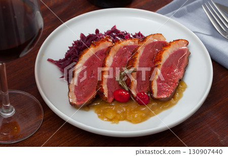 Fried duck breast Magre served with boiled cabbage and caramelized onions 130907440