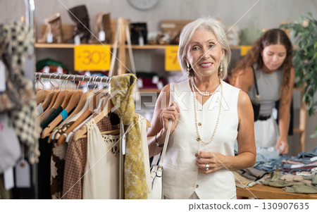 Mature woman standing during shopping in clothing store 130907635
