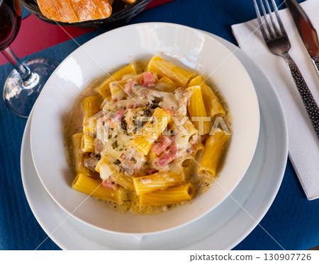Popular dish pasta Rigatoni a la carbonara 130907726