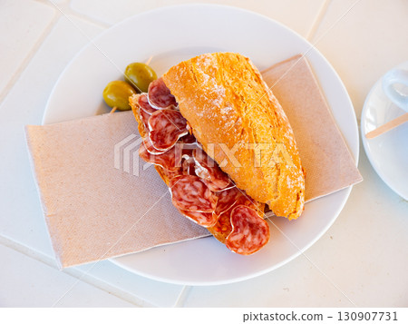 Sandwich with delicious delicaty dried sausage Fuet Sandwich with delicious delicaty dried sausage Fuet 130907731
