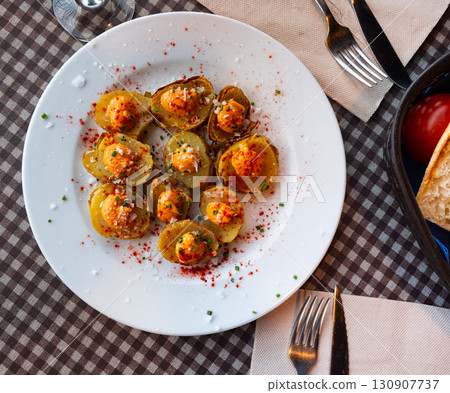Baked potatoes with aioli, chopped scallions and paprika Baked potatoes with aioli, chopped scallions and paprika 130907737