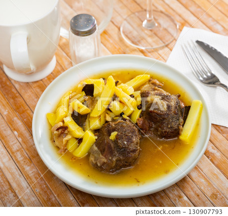 Baked pork pieces with potatoes in goulash 130907793