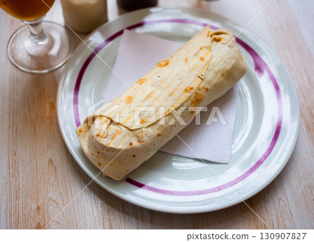 Turkish wrapped dish durum on white plate Turkish wrapped dish durum on white plate 130907827