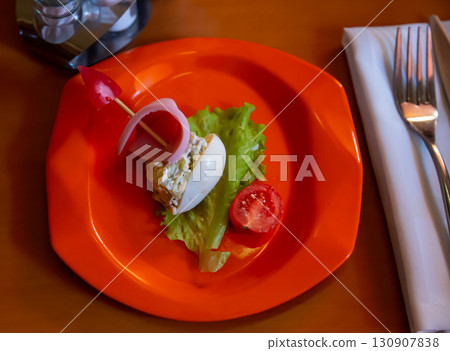 Colorful salad is decorated in form of ship. idea for children menu 130907838
