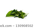 Fresh organic kaffir lime leaves, cut into pieces as a cooking ingredient. Green leaves, placed on a white background. 130908502