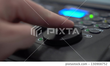 Close-up of finger adjusting Tilt shuttle on lighting console 130908752