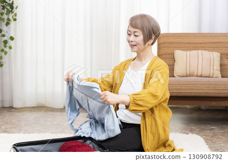 一位老年婦女打包行李準備旅行 130908792