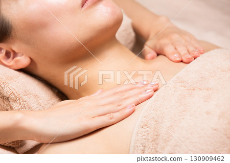 A young Asian woman is getting a decollete massage. 130909462
