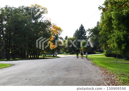 Family walking on suburban street 130909598