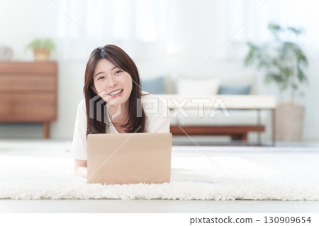 Young woman using a personal computer Young woman using a personal computer 130909654
