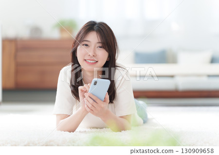A young woman using a smartphone A young woman using a smartphone 130909658