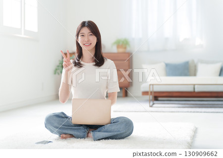 Woman working at home using a computer 130909662