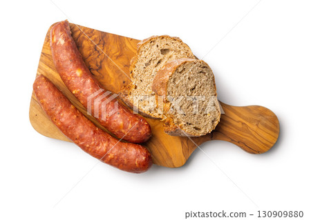 Smoked sausages and bread on cutting board isolated on white background. 130909880