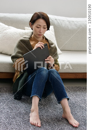 A woman operating a tablet (broken?) 130910190