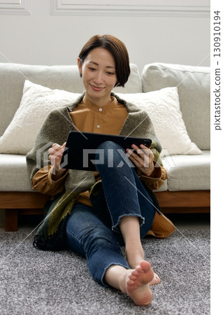 Woman operating a tablet 130910194