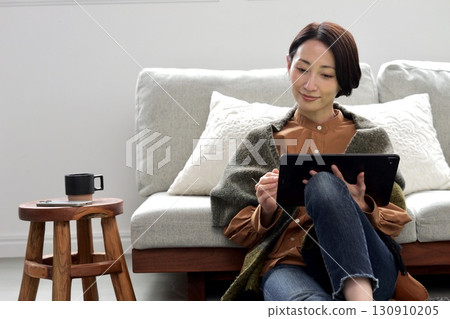 Woman operating a tablet 130910205