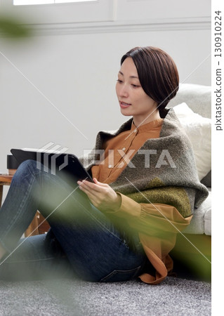 Woman operating a tablet 130910224