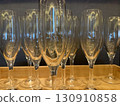 Many champagne glasses arranged on a wooden tray 130910858