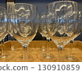 Many wine glasses arranged on a wooden tray 130910859