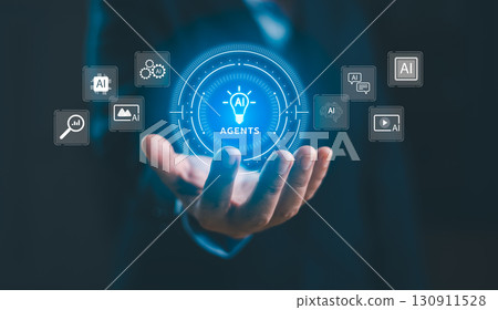 Businessman holding virtual AI agents hologram with futuristic icons. Artificial intelligence technology for automation, data analytics, digital transformation and innovative business solutions. 130911528