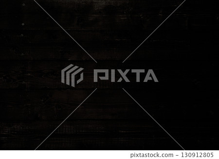 A horizontal background image of a black wooden wall with wood grain and knots A horizontal background image of a black wooden wall with wood grain and knots 130912805