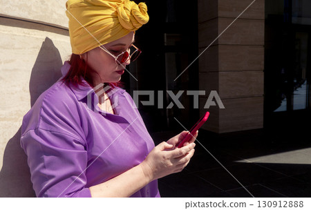 Happy adult asian with extravagant style with phone 130912888