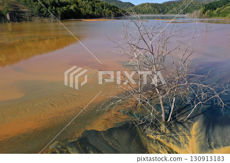 Aerial view of acid mine water drainage flow, toxic mine waters polluting the environment. Rosia Montana, Romania 130913183