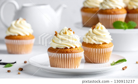 Delicious pink cupcakes decorated with swirls of sweet cream and chocolate icing for a birthday celebration 130913237